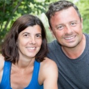 Smiling woman with shoulder-length dark hair beside a smiling man with short graying hair